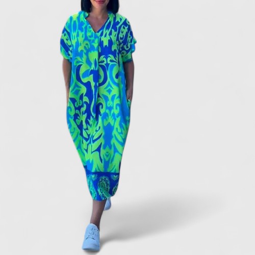 Close-up detail of the delicate floral pattern and soft, lightweight fabric of the green midi dress.