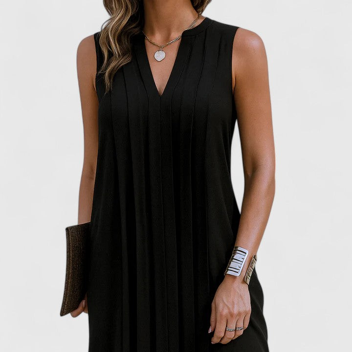 Side profile of the black midi dress, highlighting the graceful drape and comfortable fit for an elegant silhouette.