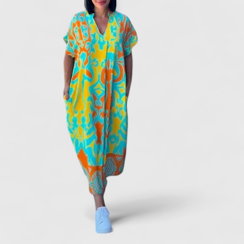 Back view of the flowing skirt and elegant silhouette of the blossoming floral midi dress in an outdoor setting.
