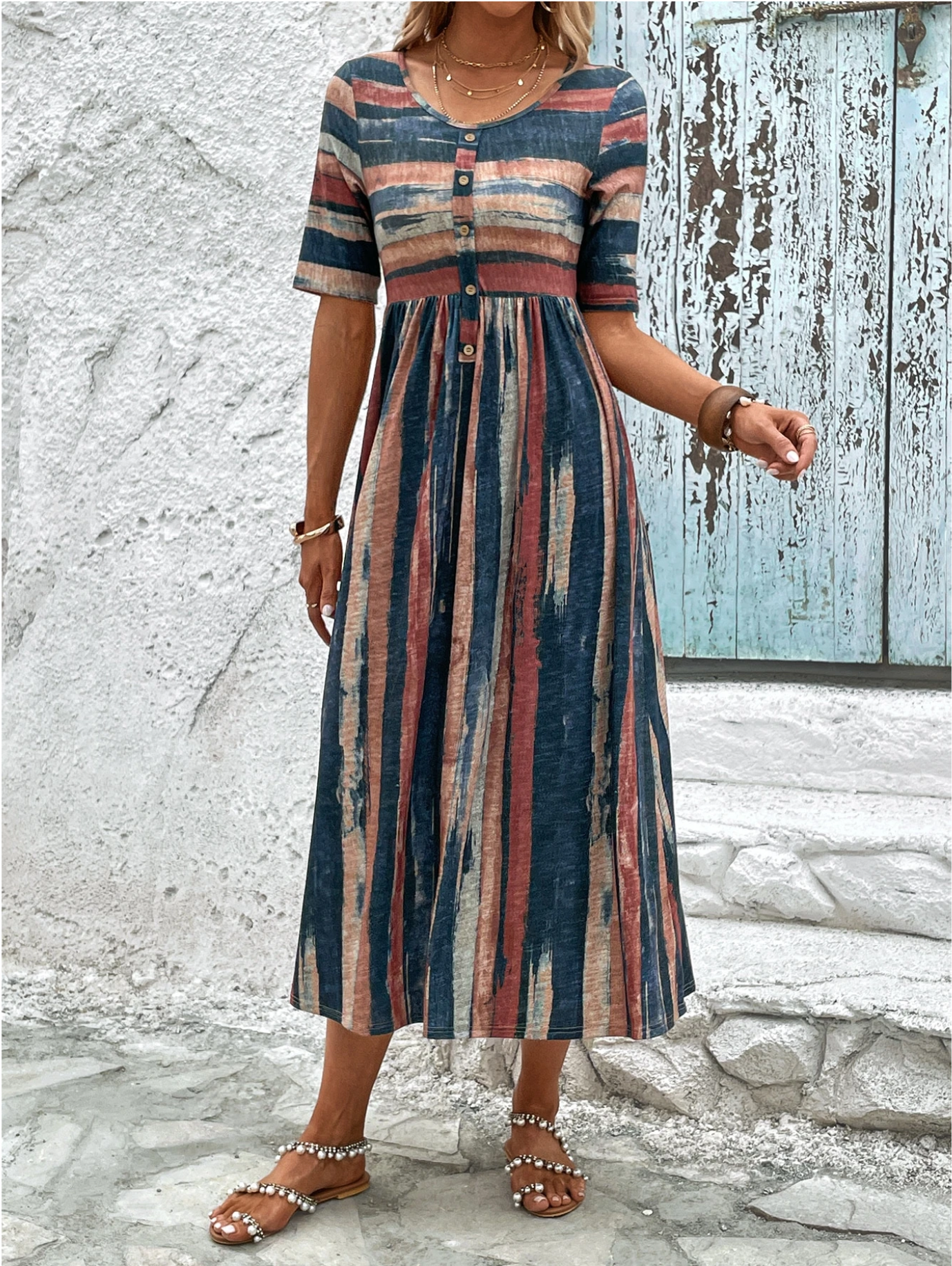 Front view of a woman confidently posing in the beautifully patterned Elara midi summer dress, showcasing its flattering fit.