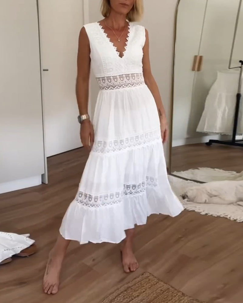 Side profile of the flowy white maxi dress, highlighting its tiered skirt design.