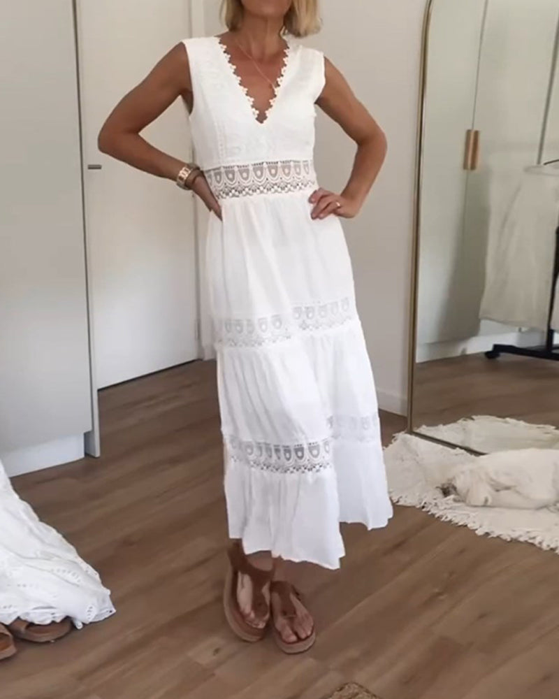 Woman wearing the white boho chic lace maxi dress, twirling in a sunlit garden.