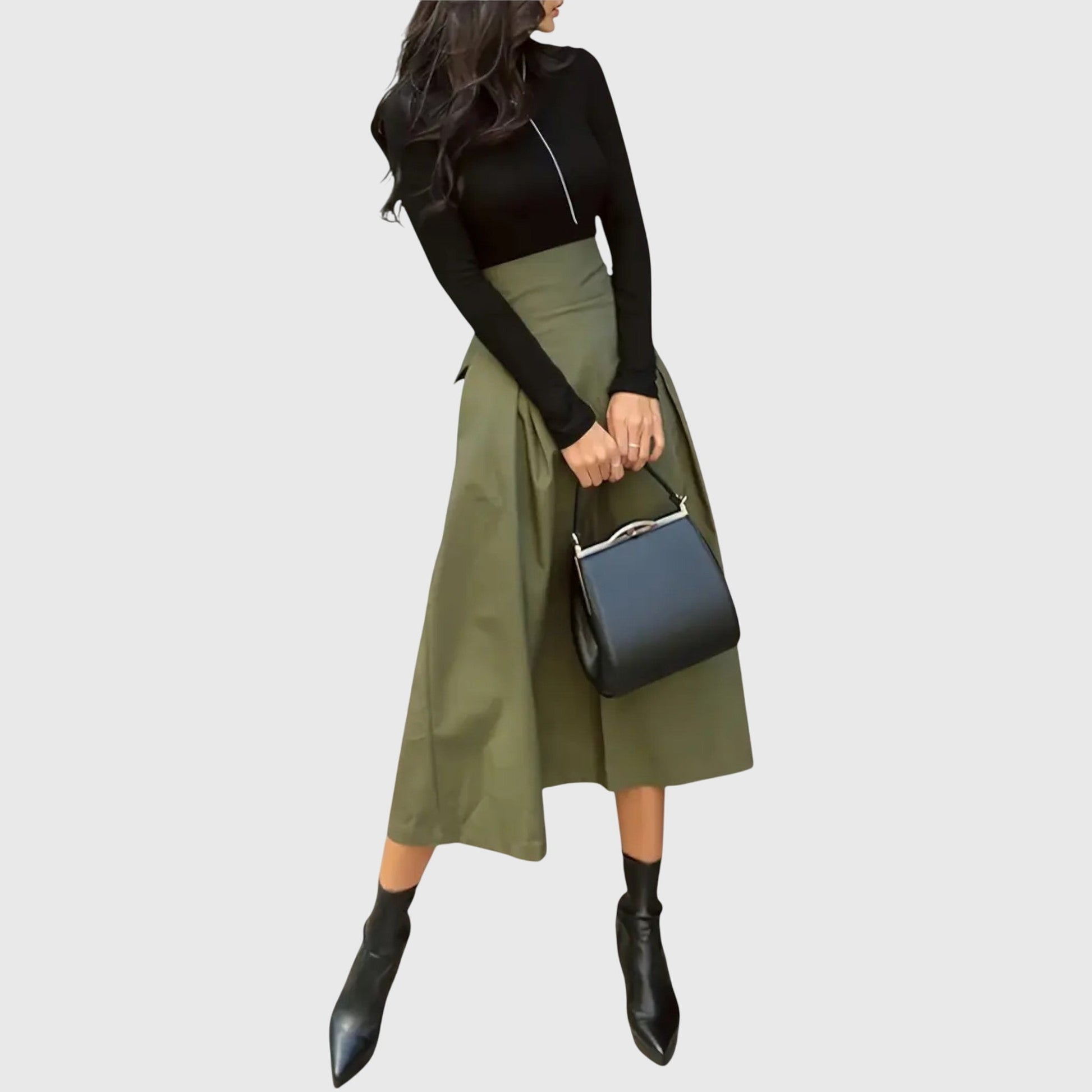 Front view of a woman wearing the green Jade flowy midi skirt, showcasing its elegant drape.