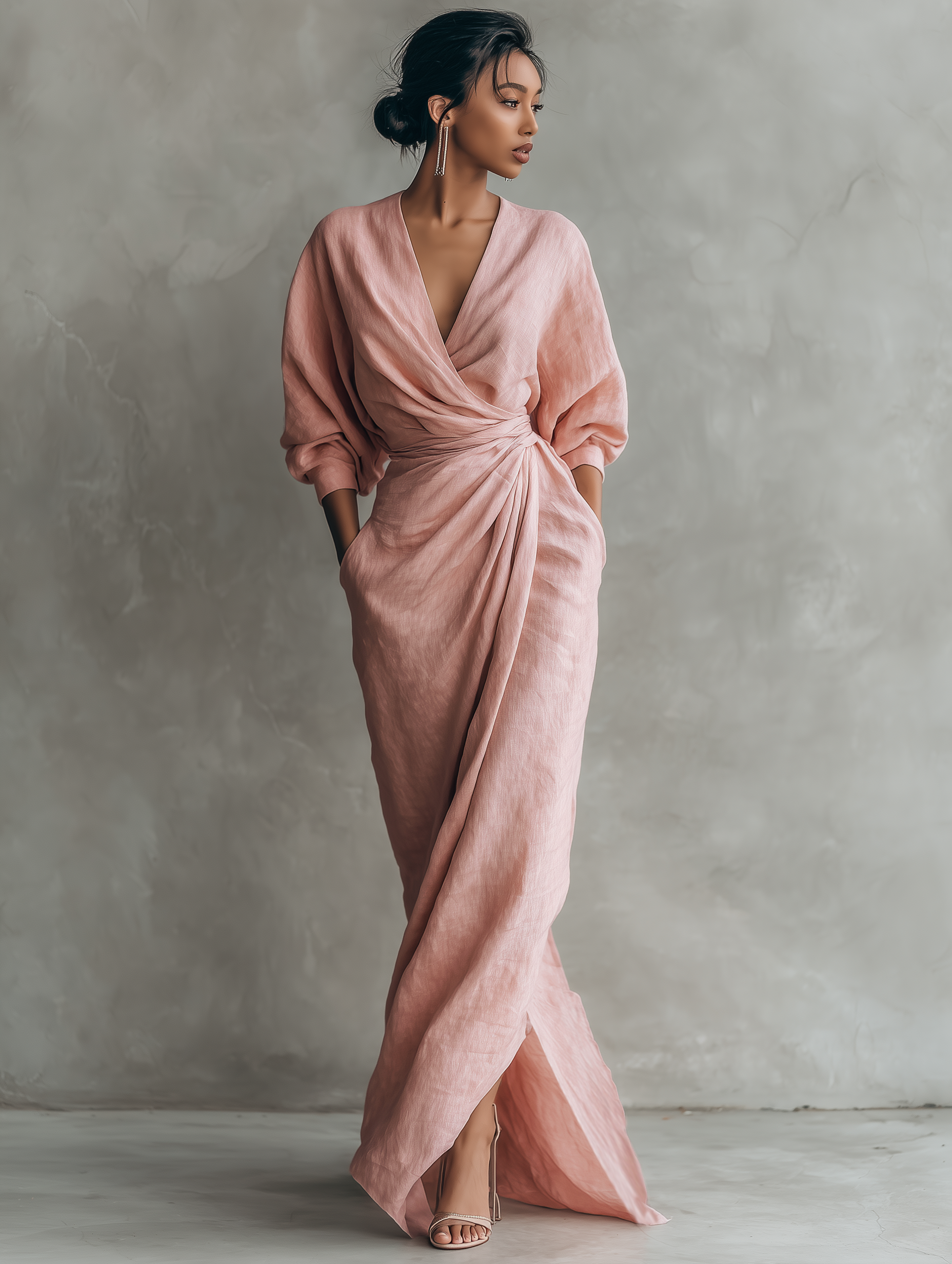 Front view of a woman wearing a light pink Marlowe maxi dress, showcasing the V-neck and flowing silhouette.