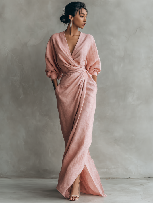 Front view of a woman wearing a light pink Marlowe maxi dress, showcasing the V-neck and flowing silhouette.