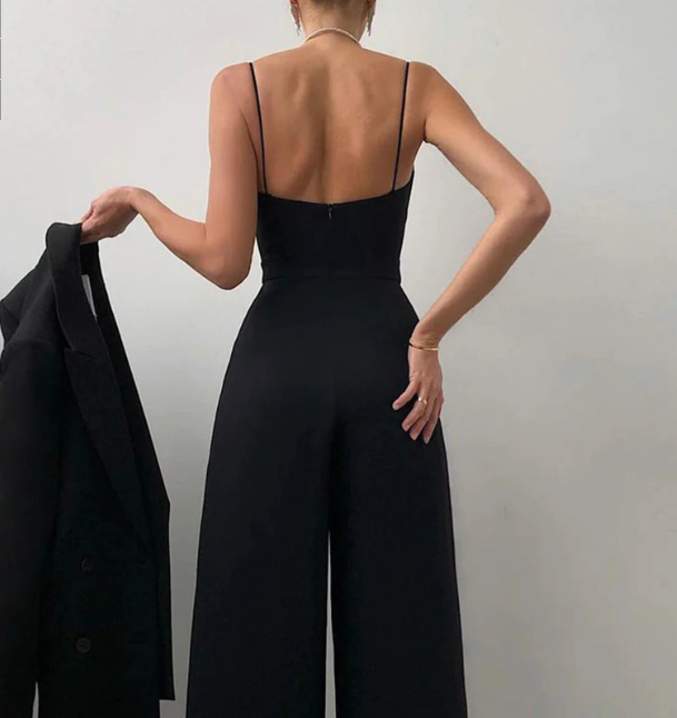 Side profile of a model wearing the vibrant pink Paloma jumpsuit, highlighting the tailored fit.
