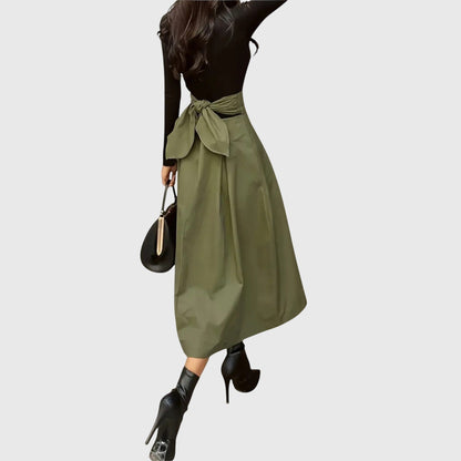 Close-up detail of the fabric and high-waisted band of the Jade midi skirt in a vibrant green hue.