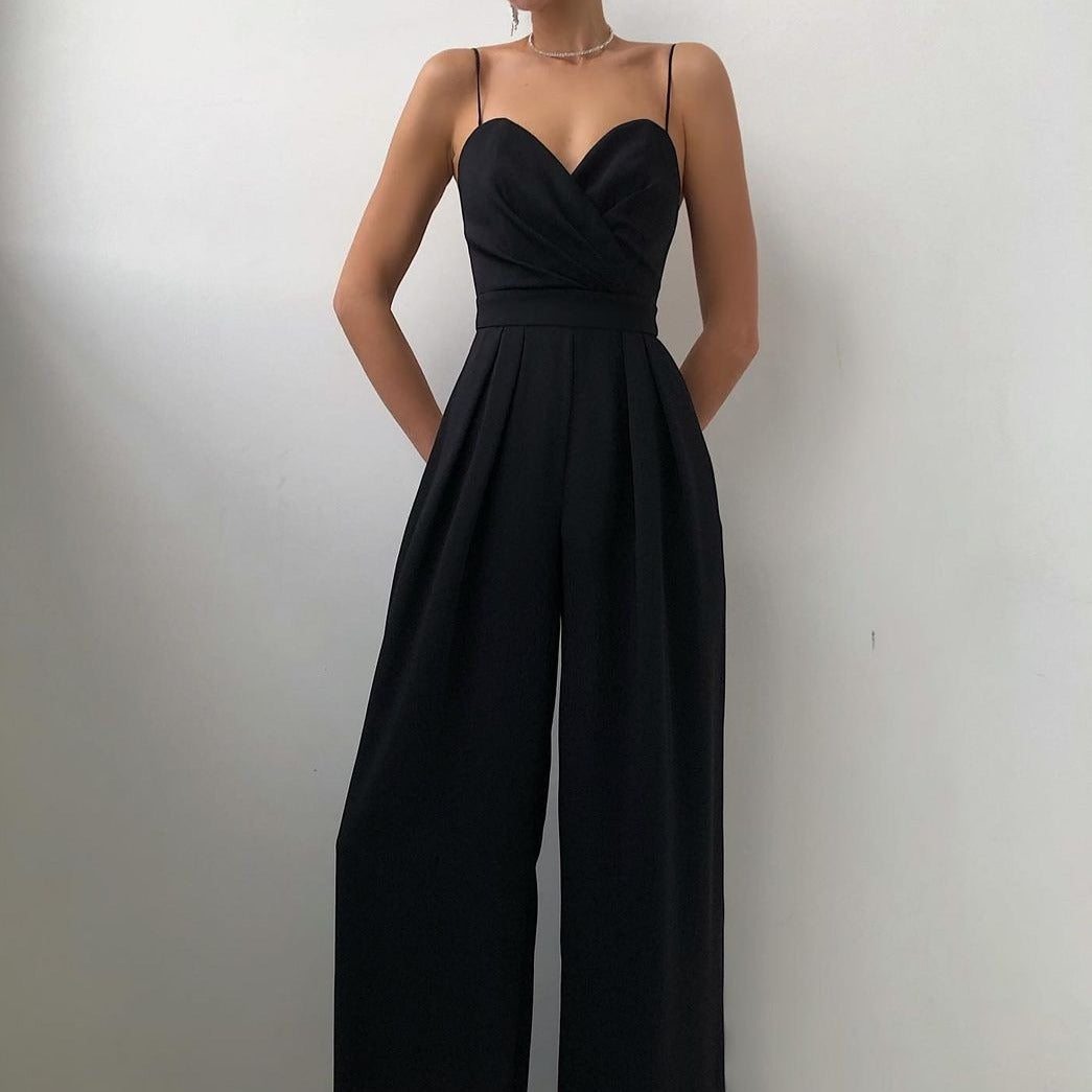 Close-up detail of the adjustable straps on the turquoise Paloma jumpsuit, showing premium hardware.