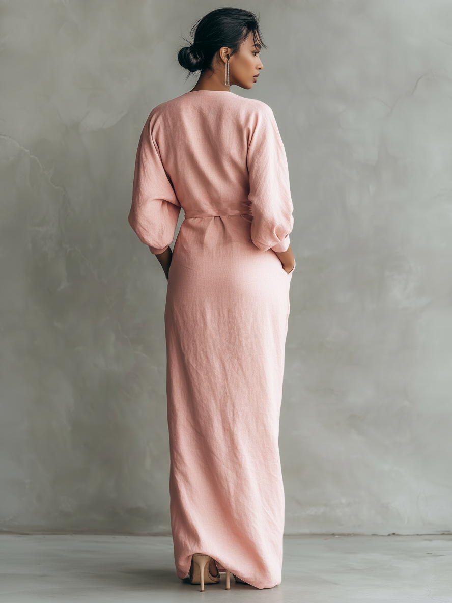 Side profile of a woman walking in the brown Marlowe maxi dress, emphasizing the relaxed and elegant drape.