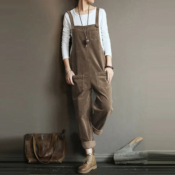 Front view of a woman wearing the Lyra flowy sleeveless jumpsuit in a solid color, showcasing its relaxed fit and elegant drape.