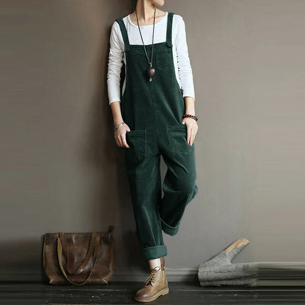 Side profile of a woman confidently posing in the Lyra flowy sleeveless jumpsuit, emphasizing its flattering silhouette.