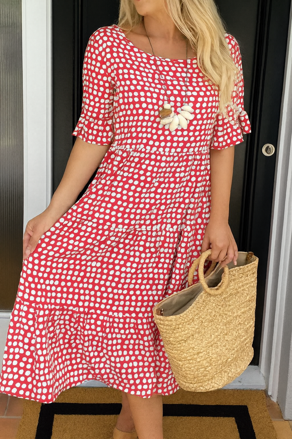 Model posing in the Kaelani chic midi dress in yellow, showing its ease of movement and flattering cut.