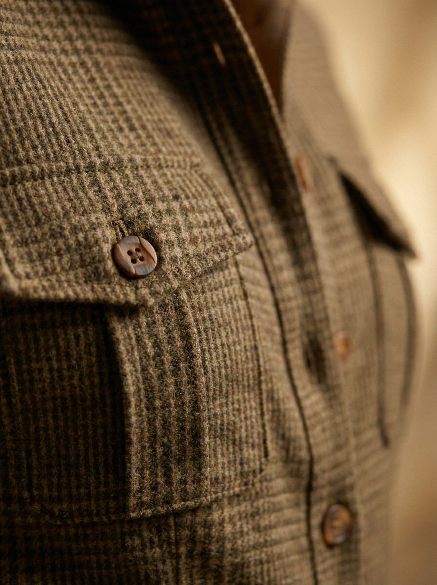 Side profile of a woman confidently posing in the brown checkered jumpsuit, highlighting its flattering silhouette.