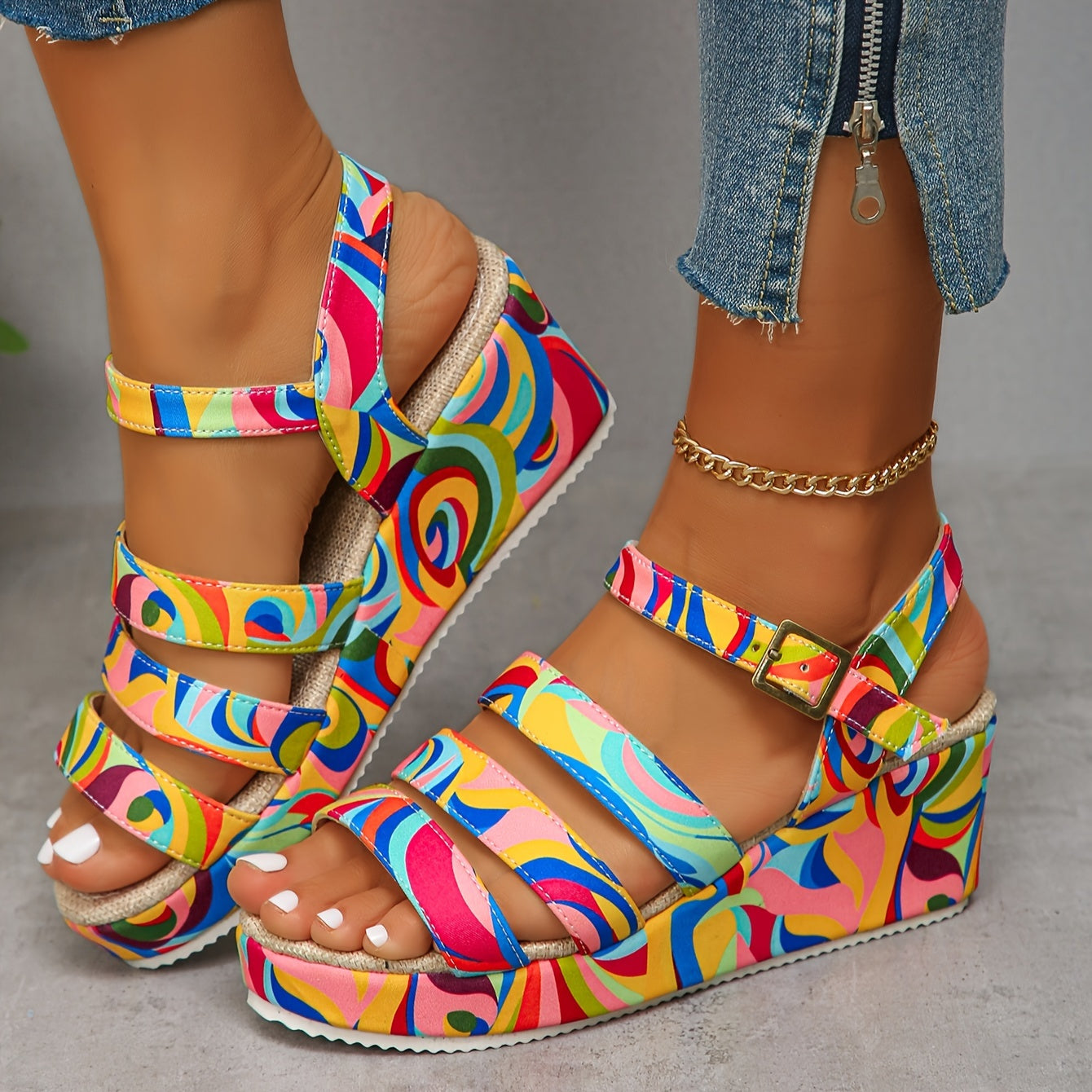 Front angled view of the vibrant platform sandals with a colorful patterned strap and ankle buckle closure.