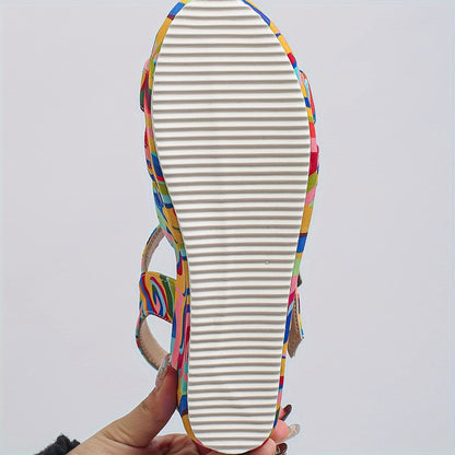 Close-up detail of the adjustable ankle strap and buckle on the vibrant platform sandals, showing texture and color.