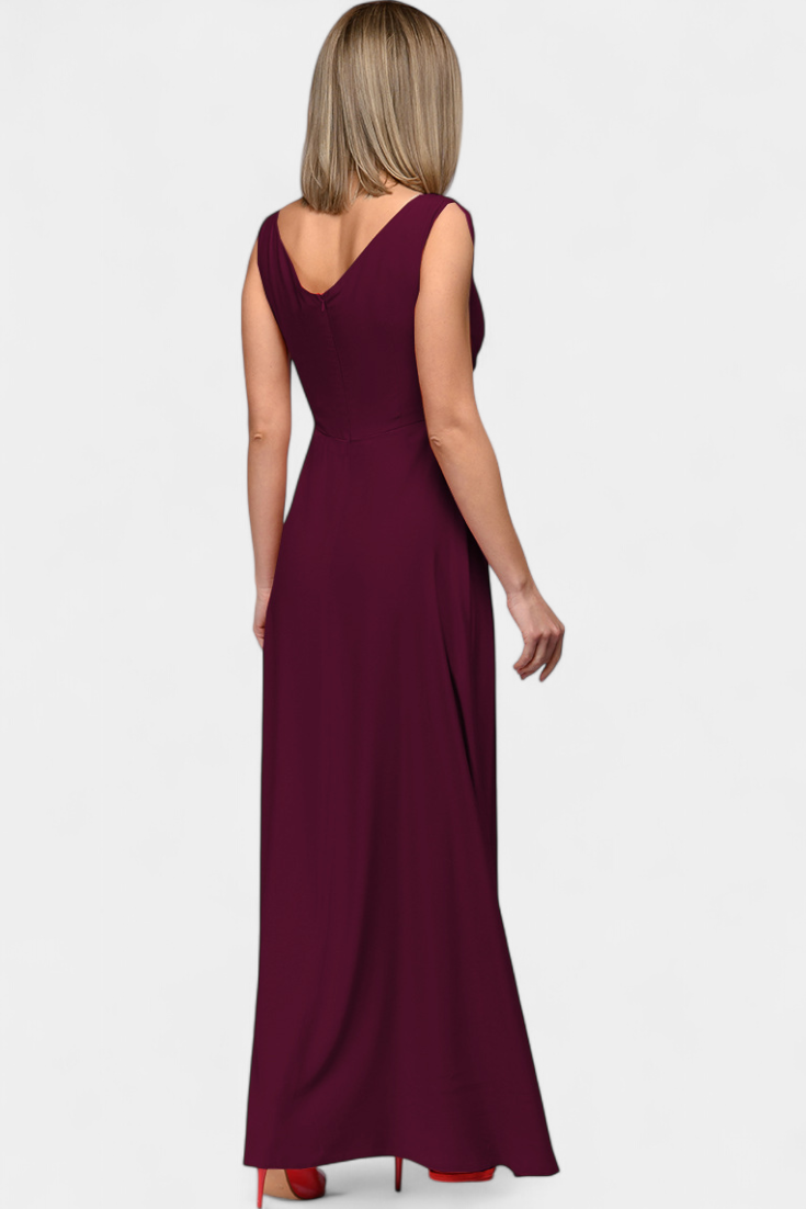 Side profile of the model in a green Lila Draped Maxi Dress, highlighting the flowing maxi skirt.