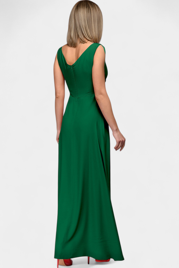 Rear view of the model in a blue elegant draped maxi dress, emphasizing the back silhouette and skirt flow.