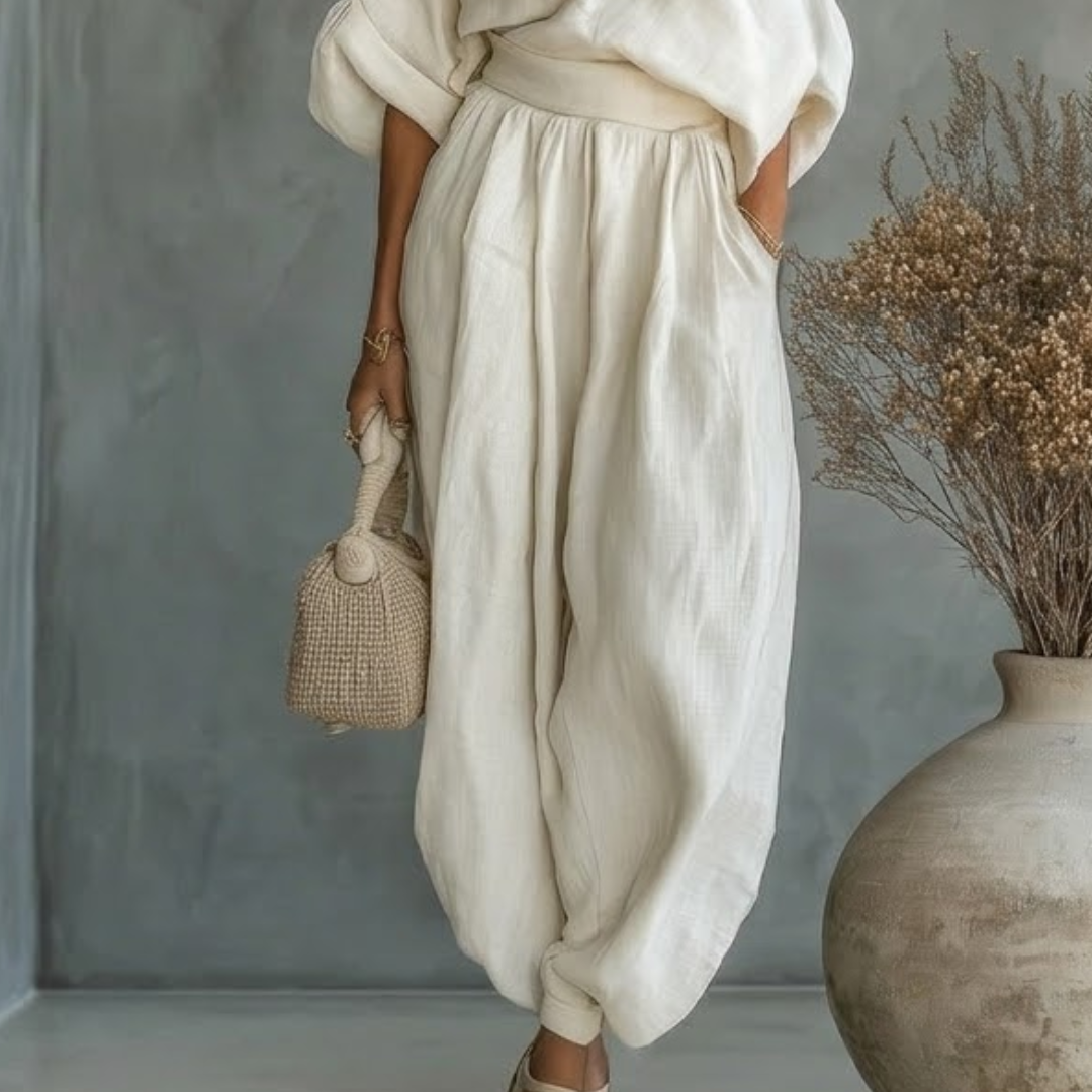 Side profile of a woman enjoying a relaxed moment in the comfortable white two-piece set.