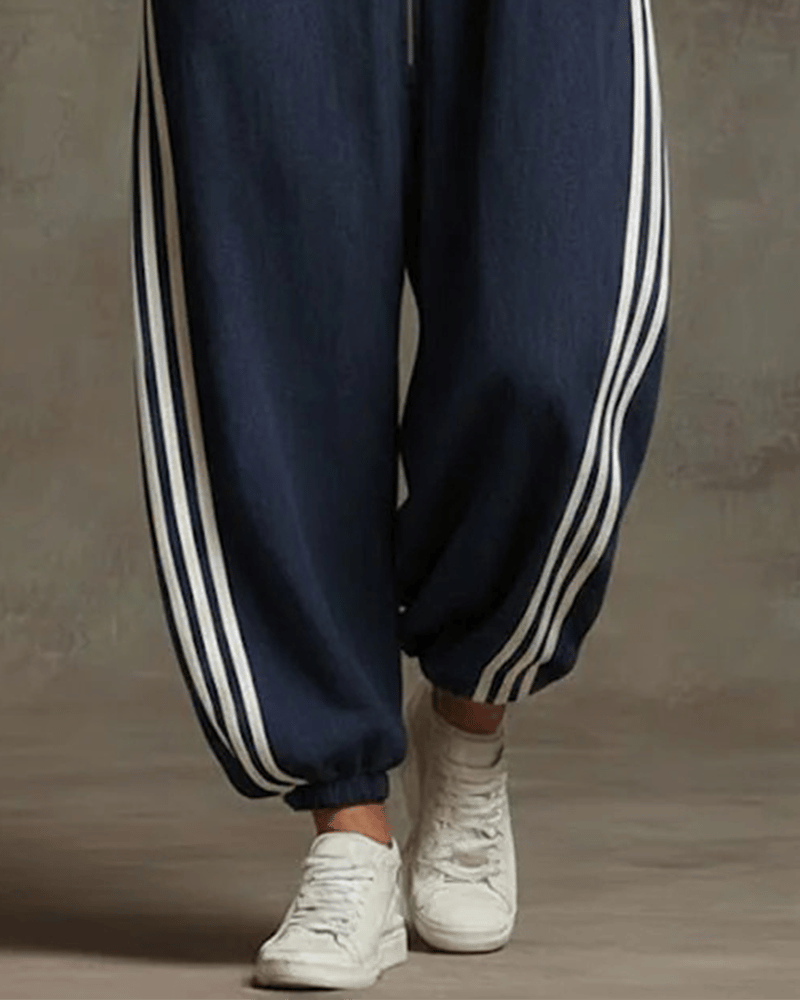 Back view of a woman in the dark blue Lotte Women's Jumpsuit, highlighting the overall silhouette.