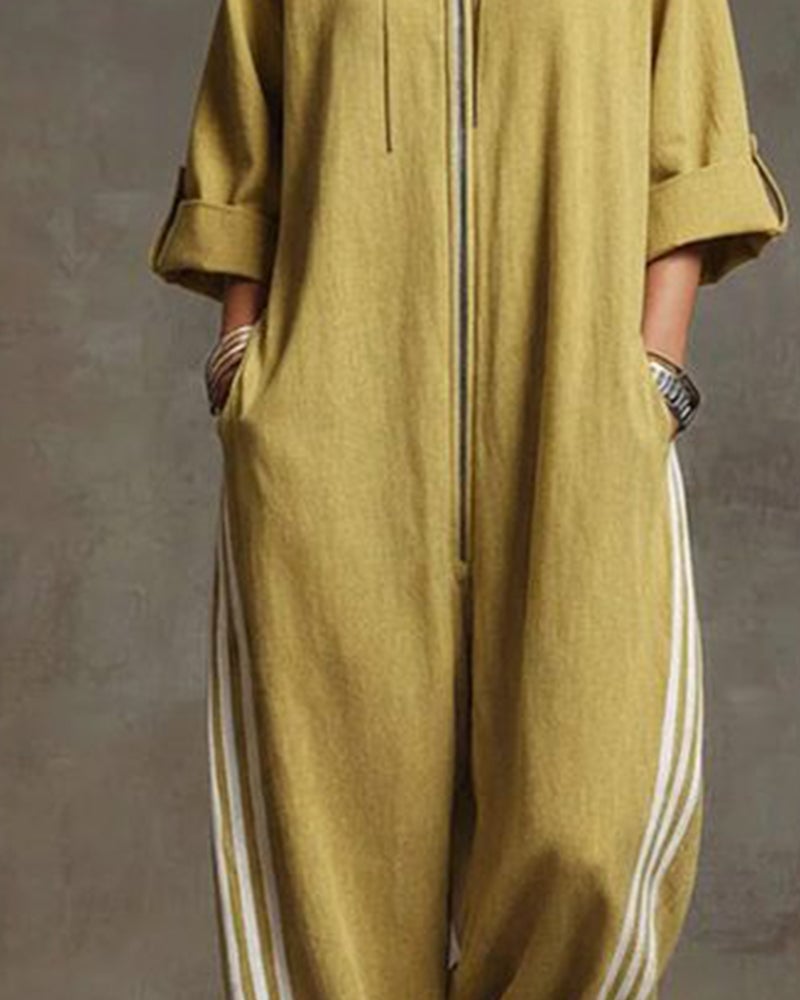 Detail shot of the athletic side stripe on the leg of the white Lotte Women's Jumpsuit.