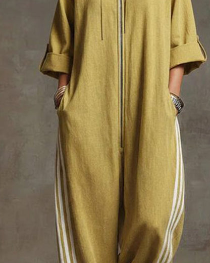 Detail shot of the athletic side stripe on the leg of the white Lotte Women's Jumpsuit.