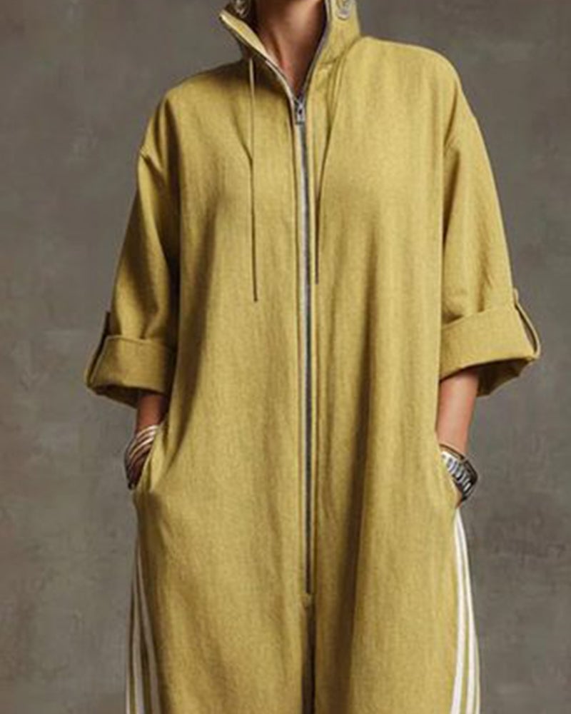 Woman walking in the dark blue Lotte Women's Jumpsuit, demonstrating ease of movement and style.