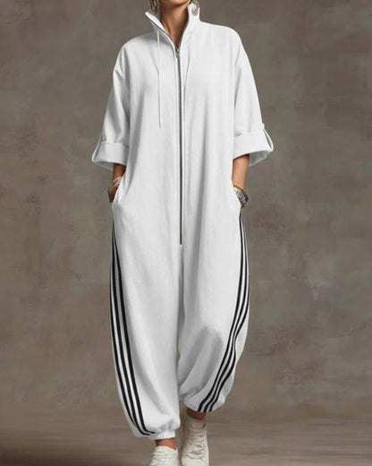 Woman sitting casually, showing the relaxed fit and comfortable stretch of the white Lotte Women's Jumpsuit.