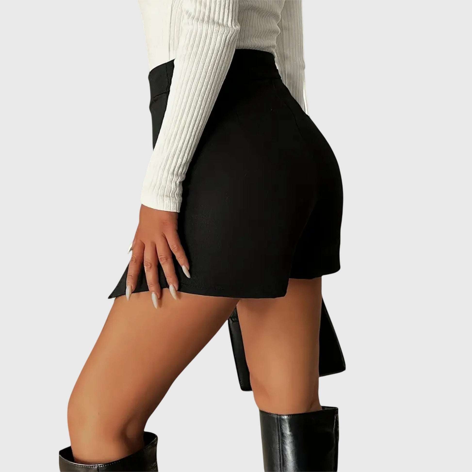 Lifestyle shot of a woman wearing the black Luna structured mini skirt, paired with a blouse, walking confidently outdoors.