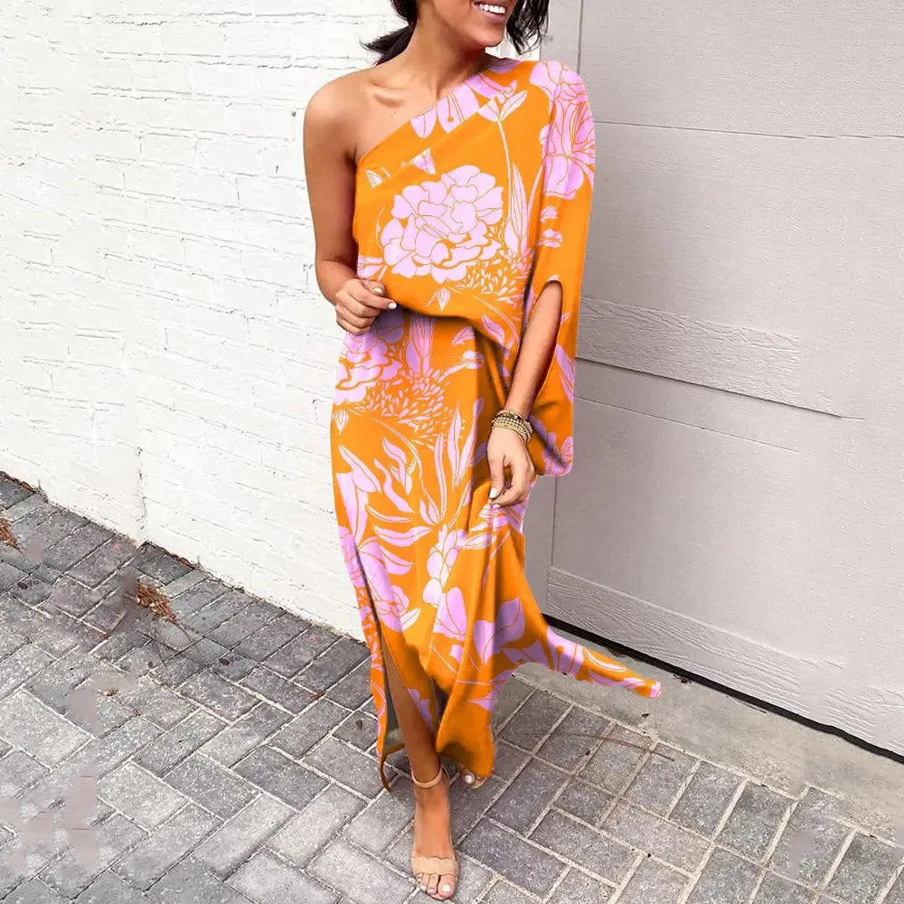Detailed shot of the one-shoulder neckline and sleeve of the vibrant floral summer dress.