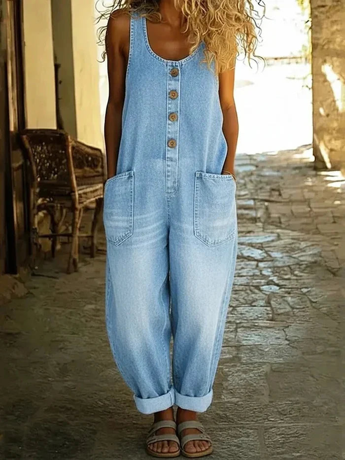 Woman wearing light blue Margot vintage-inspired dungarees, side profile, styled with a white top.