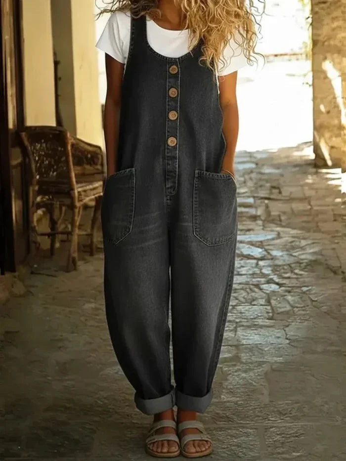 Full-body front view of a woman posing in light blue Margot vintage-inspired dungarees, hands in pockets.
