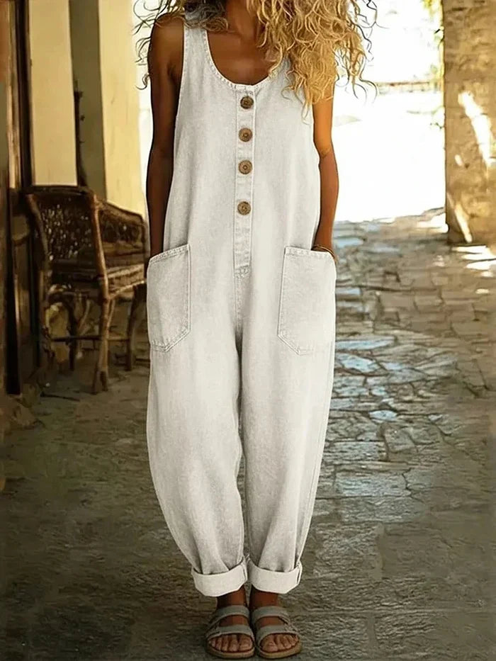 Back view of the woman wearing light blue Margot vintage-inspired dungarees, showcasing the adjustable straps.