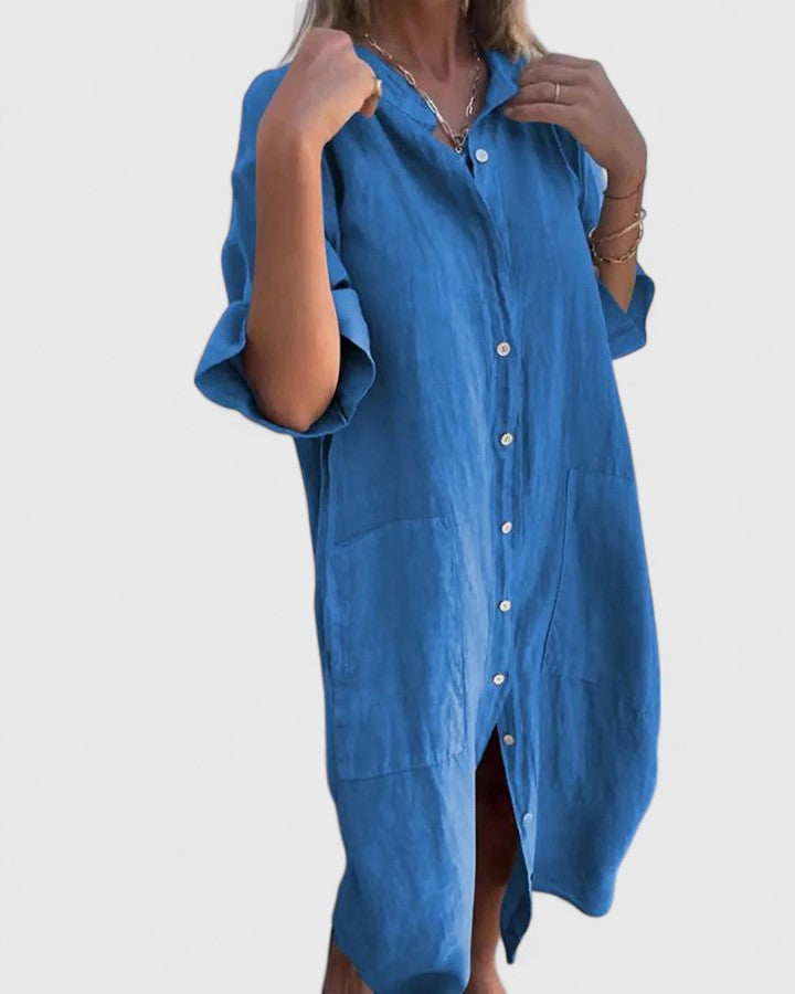 Front view of a woman wearing the Mila relaxed dress in a vibrant blue color, styled casually.