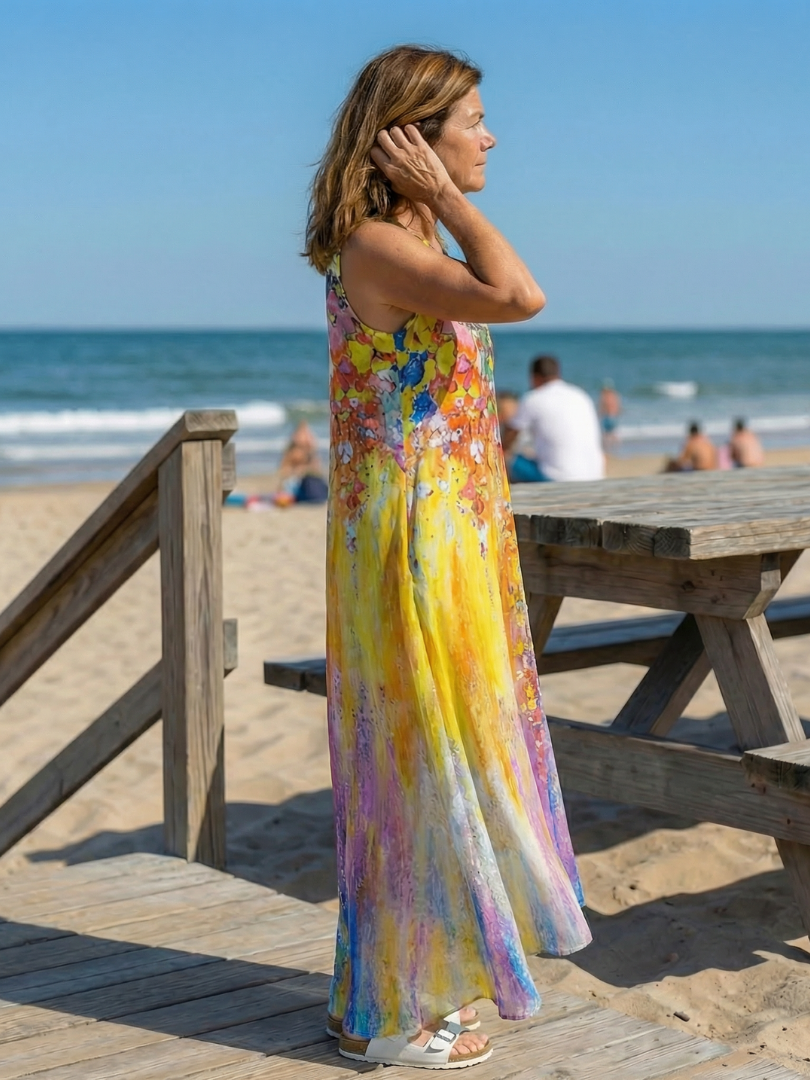 Side profile of the flowing Callisto open air maxi dress, highlighting the lightweight fabric and elegant drape.