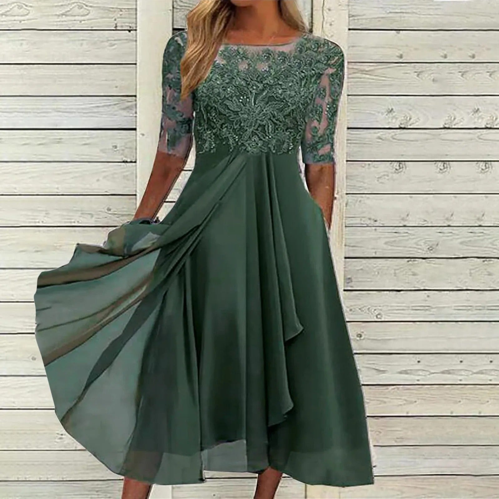 A vibrant green embroidered chiffon dress laid flat, displaying the full design and rich color of the elegant garment.