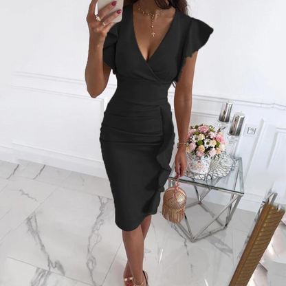 Woman laughing and enjoying herself while wearing the beautiful floral V-neck dress, perfect for summer.