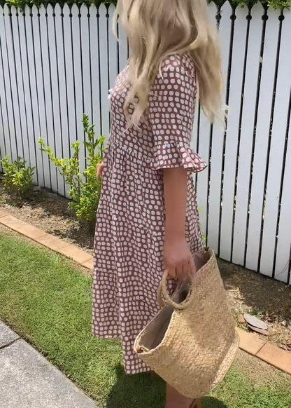 Side profile of the brown boho midi dress, highlighting its flowing silhouette and comfortable drape.