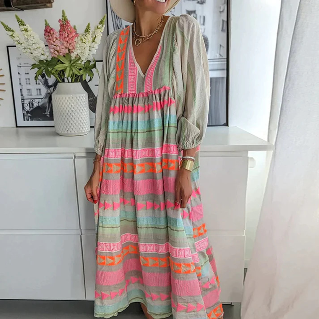 Side profile of the woman in the boho patchwork midi dress, highlighting the elegant V-neck and puffed sleeves.