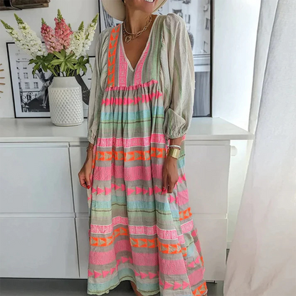 Side profile of the woman in the boho patchwork midi dress, highlighting the elegant V-neck and puffed sleeves.