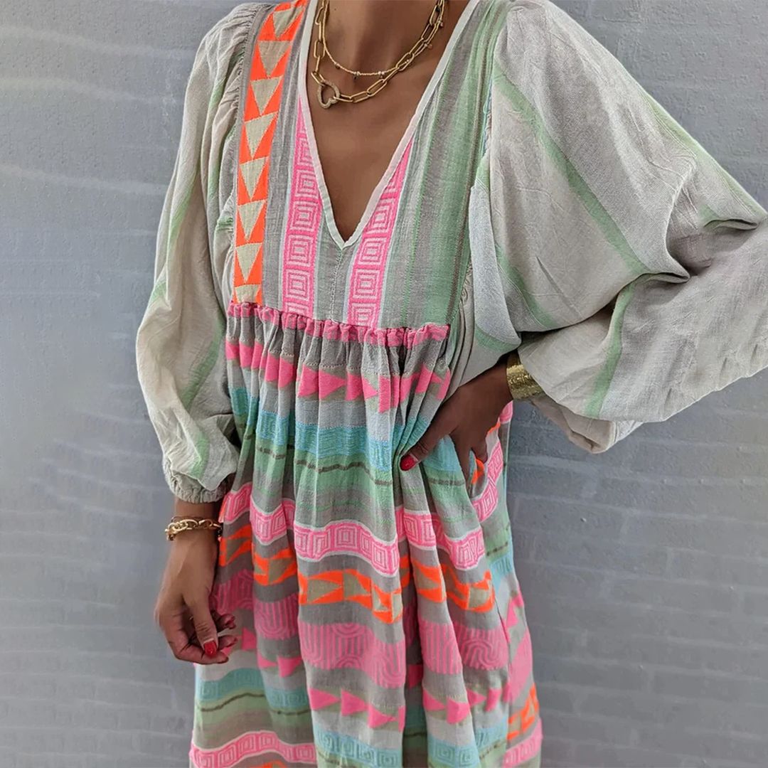 Back view of the flowing boho patchwork midi dress as a woman walks, emphasizing its relaxed and airy fit.