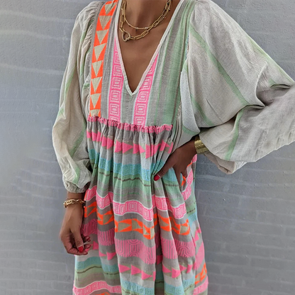 Back view of the flowing boho patchwork midi dress as a woman walks, emphasizing its relaxed and airy fit.