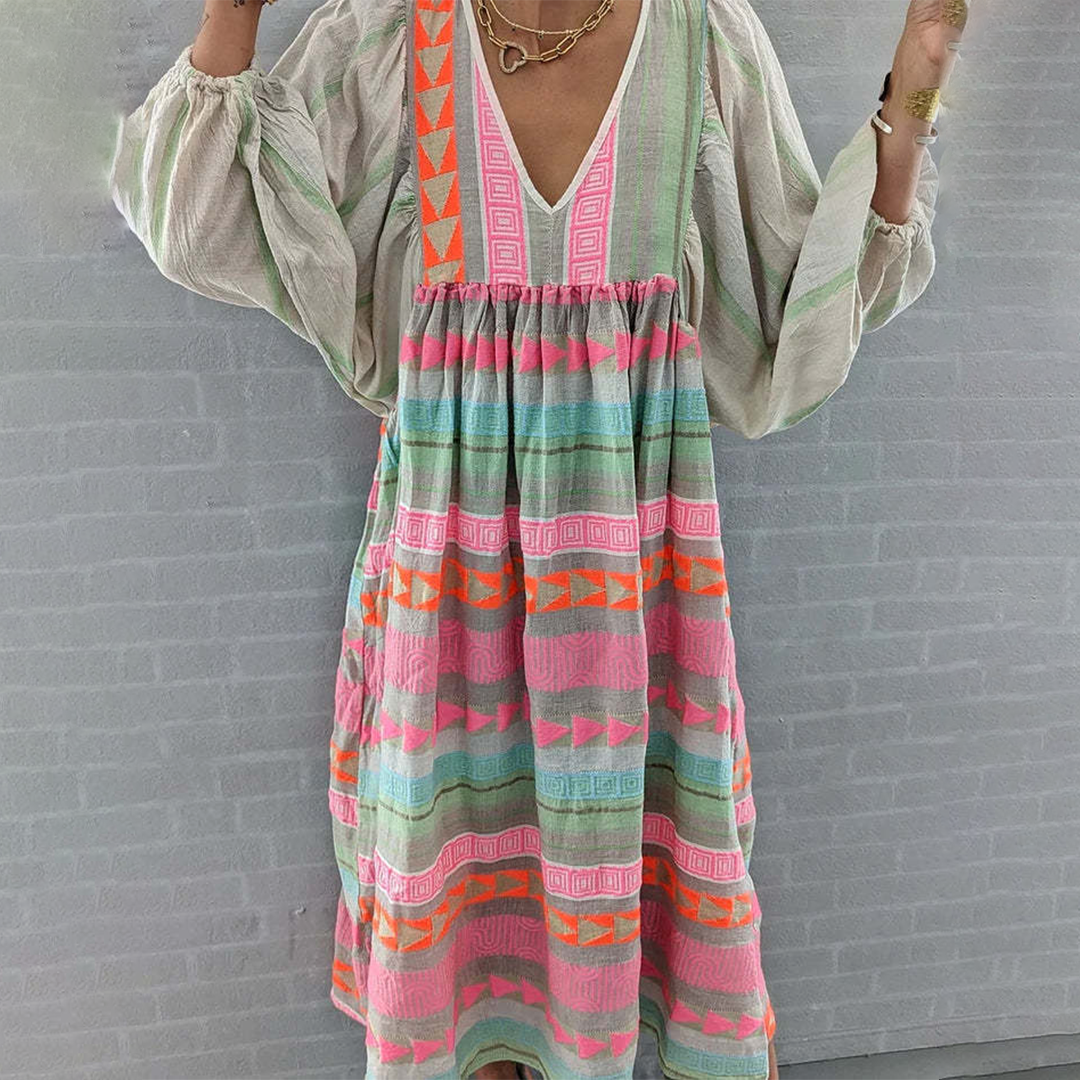 Lifestyle shot of the woman enjoying a sunny day outdoors in her comfortable and stylish boho patchwork midi dress.