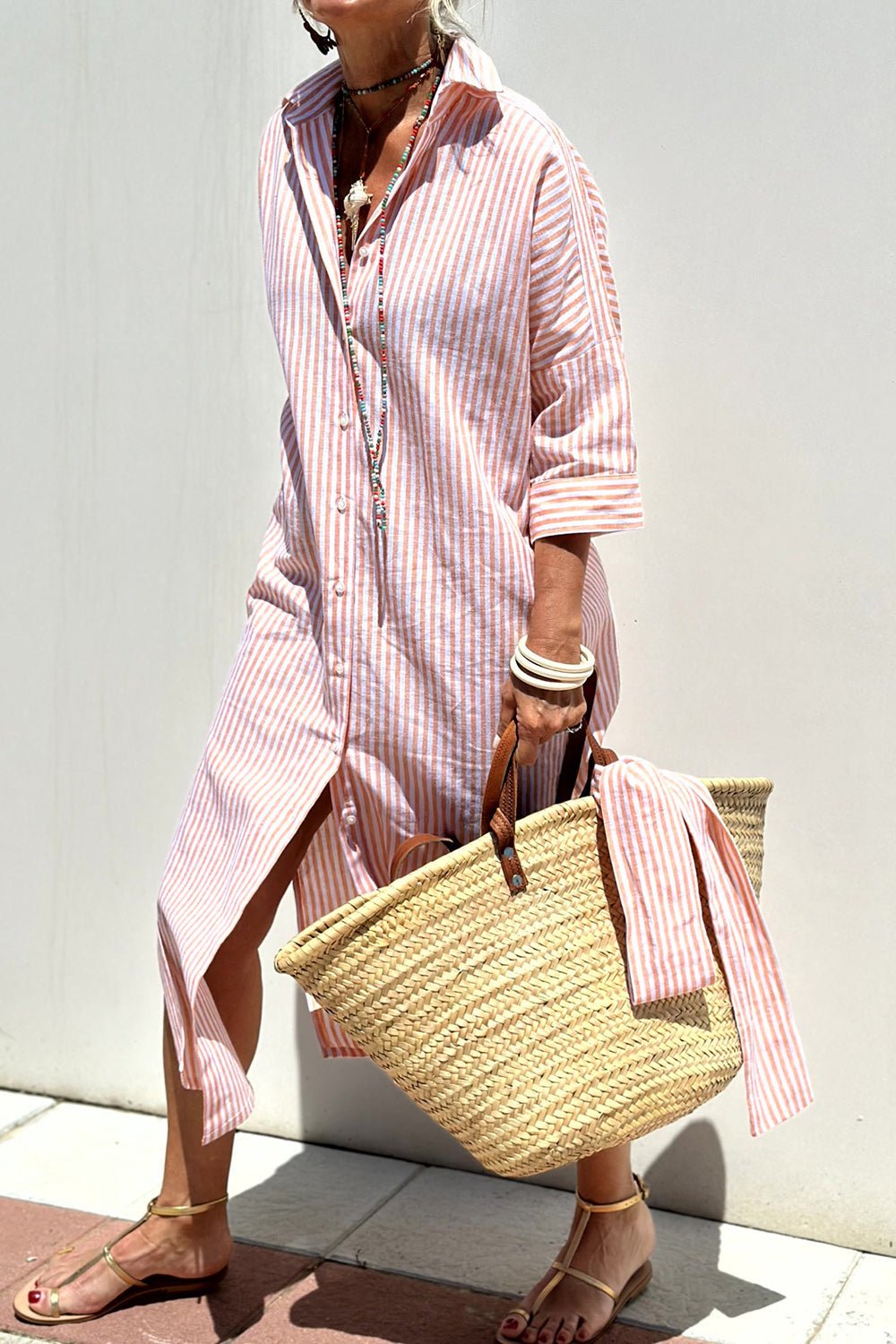 Front view of the Paloma striped shirt dress in pink, showcasing its relaxed fit and midi length.