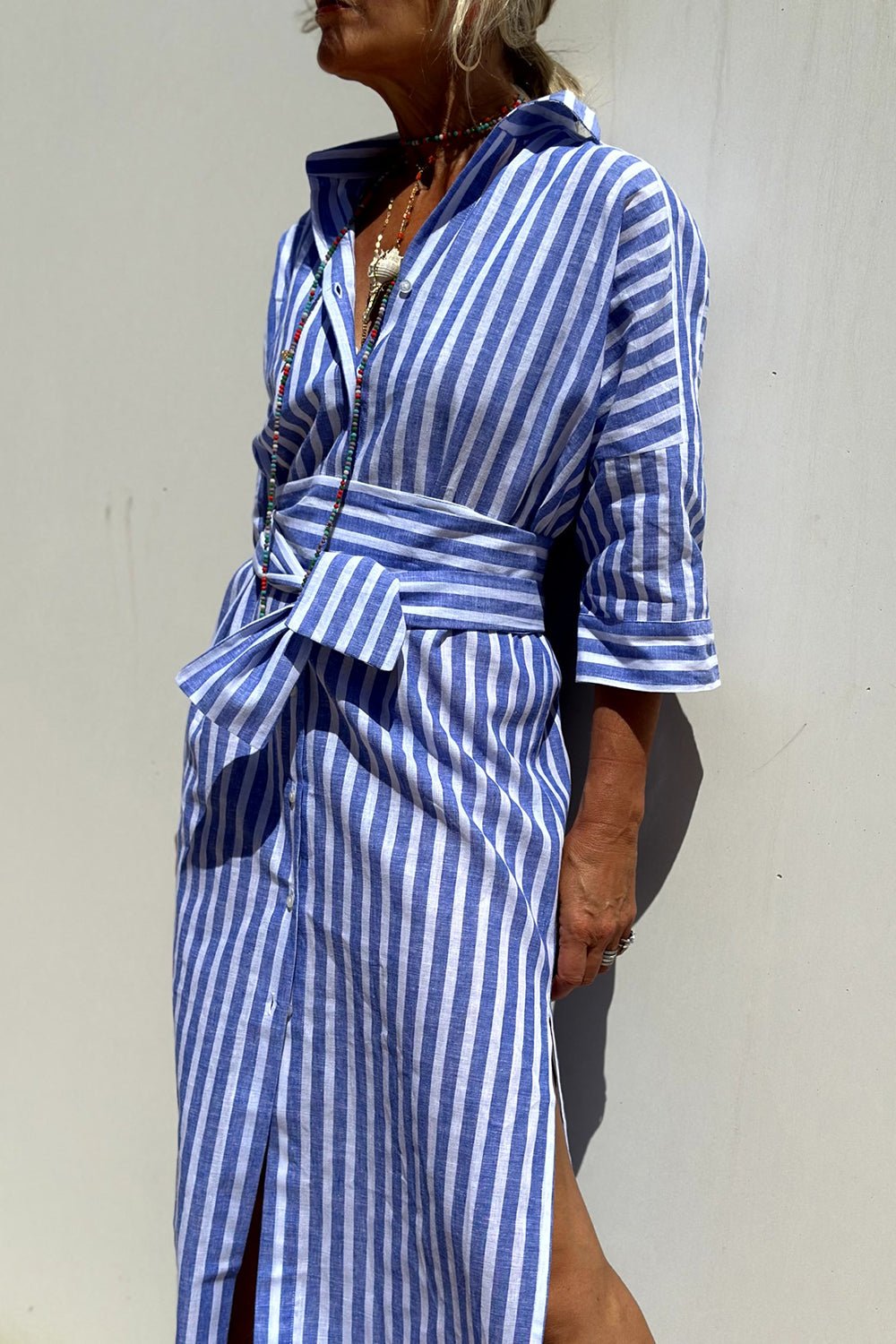 Back view of the Paloma striped shirt dress, emphasizing its flowy silhouette and comfortable design.