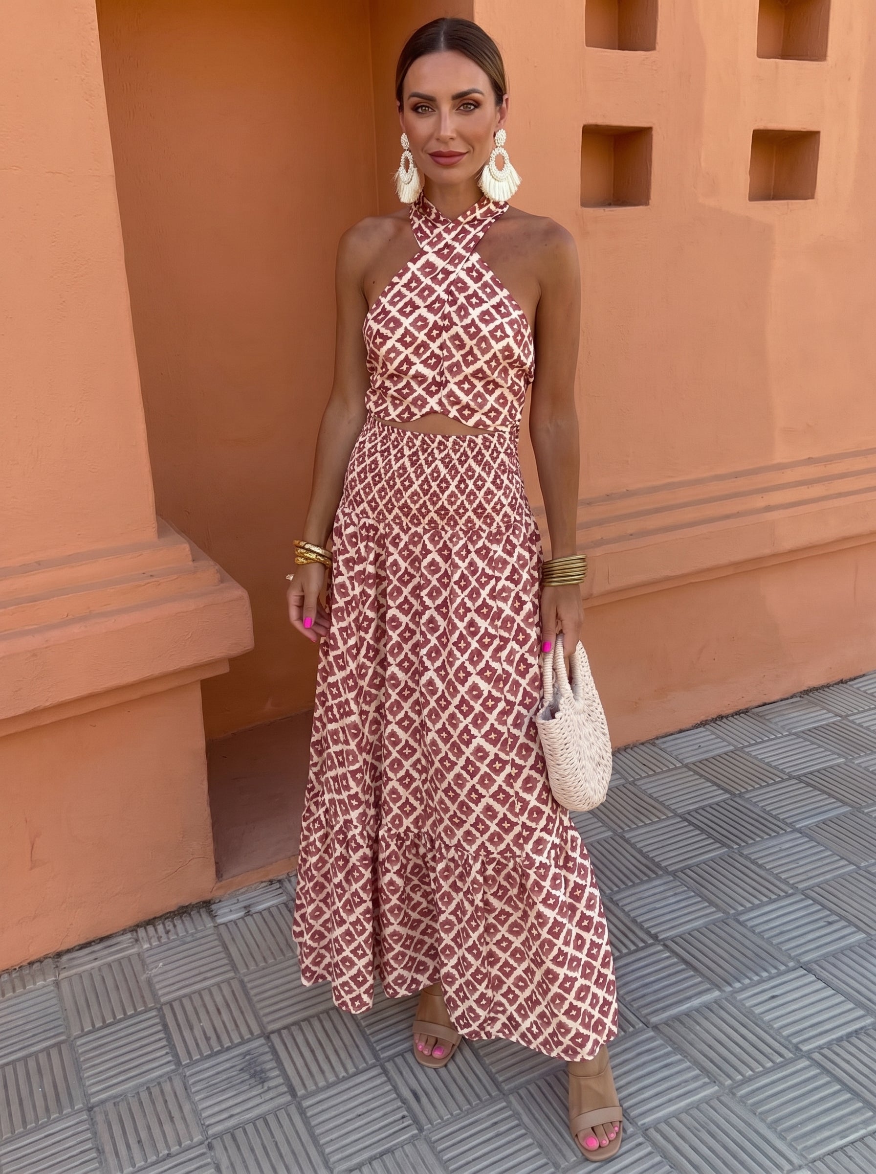 Front view of a woman wearing the blush pink elegant off-shoulder set, standing gracefully with a soft smile.