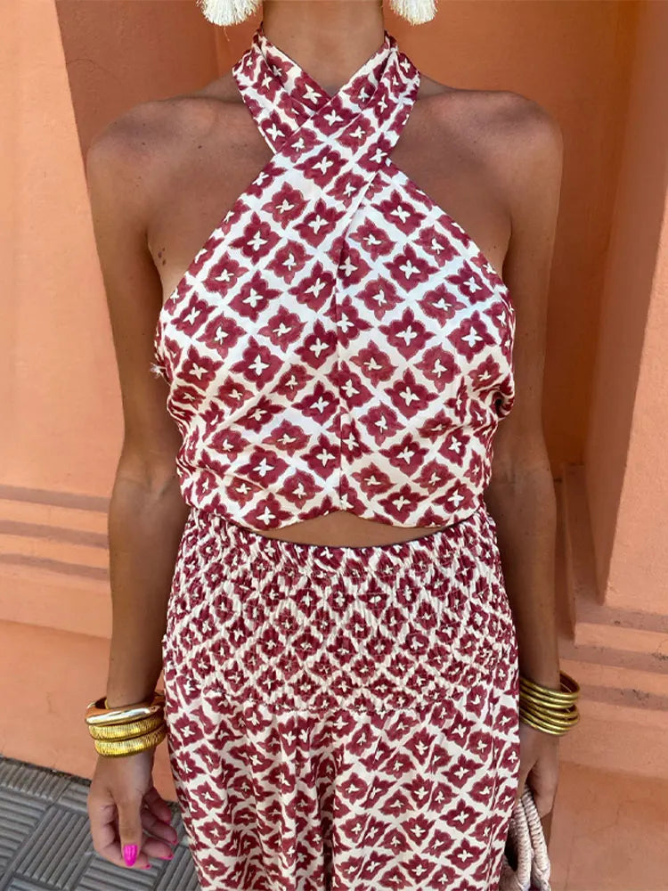 Close-up detail of the ruffled high-waist skirt and the gentle drape of the off-shoulder top on the elegant set.