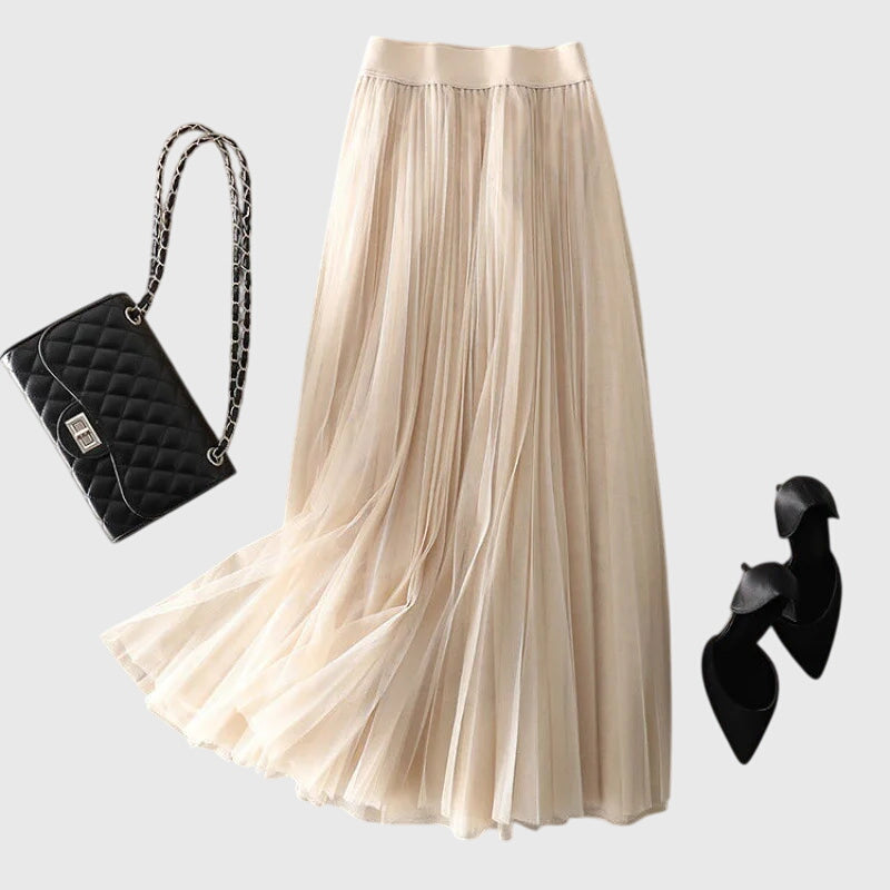 Model wearing the Seraphina pleated midi skirt in black, styled casually for a chic everyday look with a top and sandals.