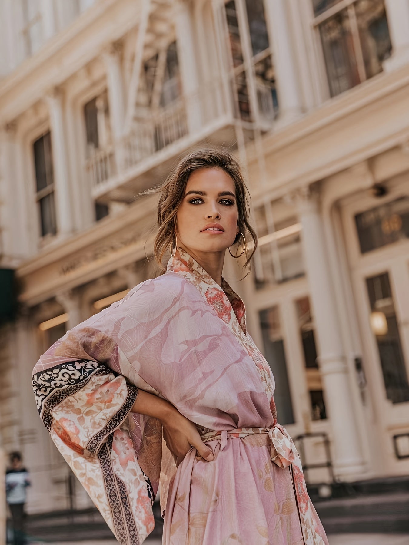 Woman relaxing poolside, wearing the Seraphina flowy floral kimono as a stylish cover-up.