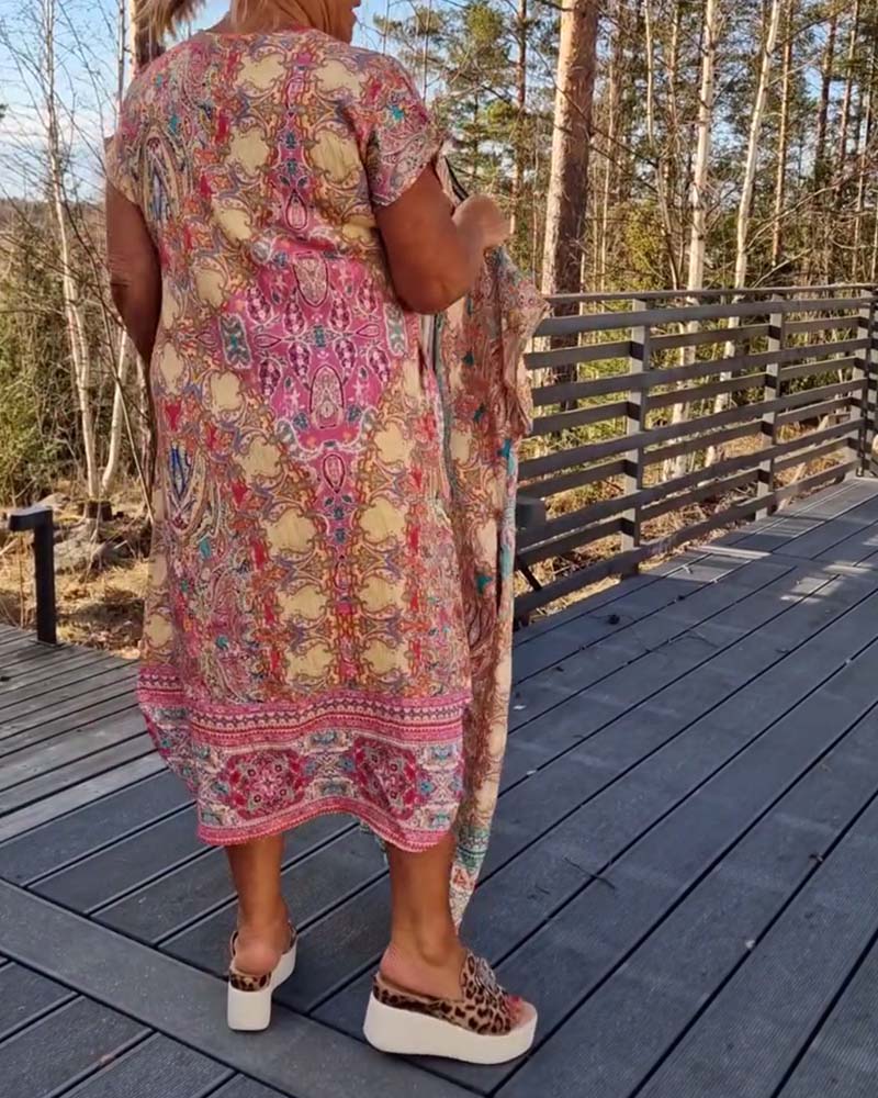 Close-up of the elegant print fabric on the Saskia V-neck midi dress, showing texture and color.