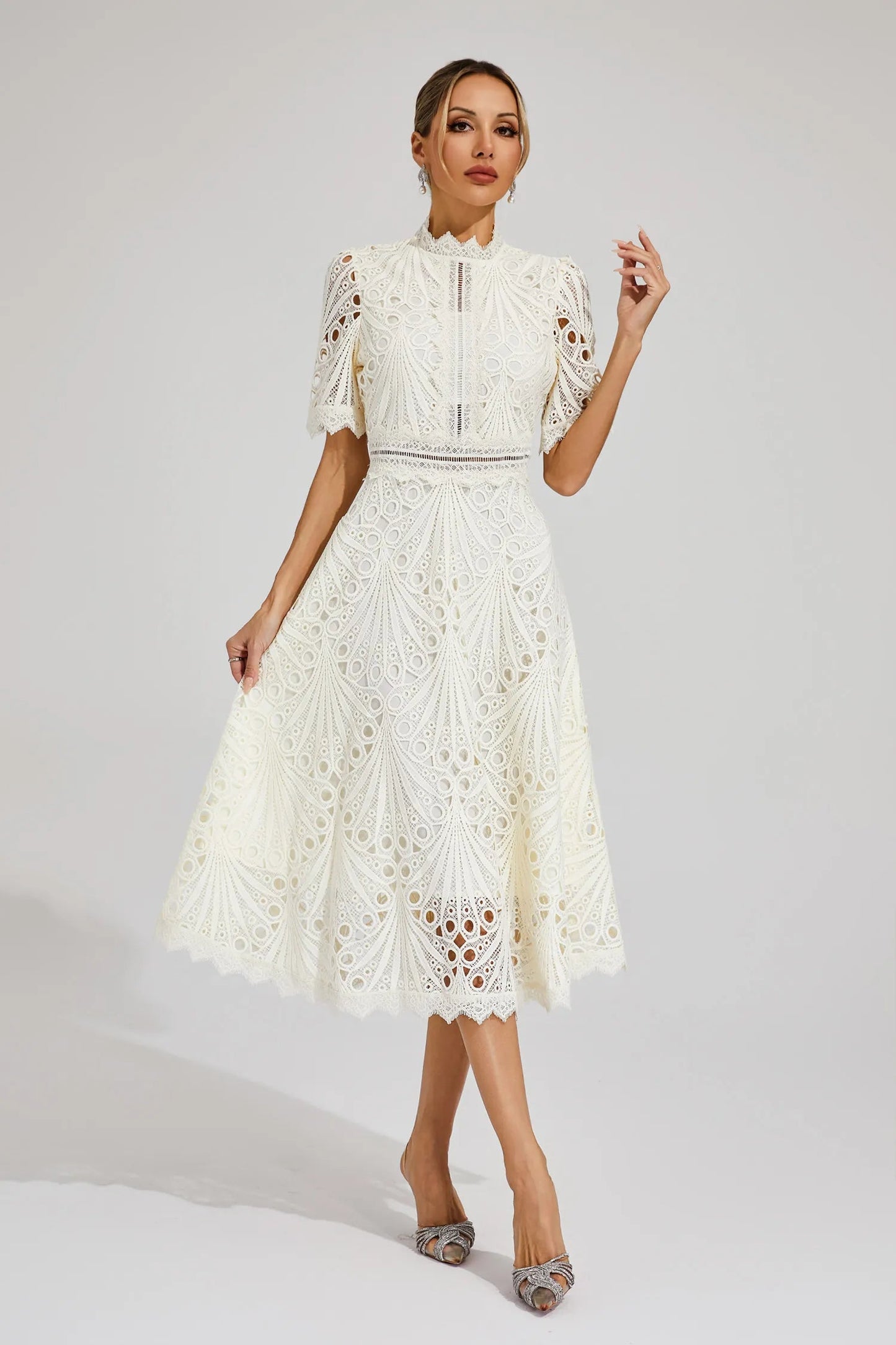 Front view of the white Seraphina lace midi dress, showcasing its high neck and short sleeves.